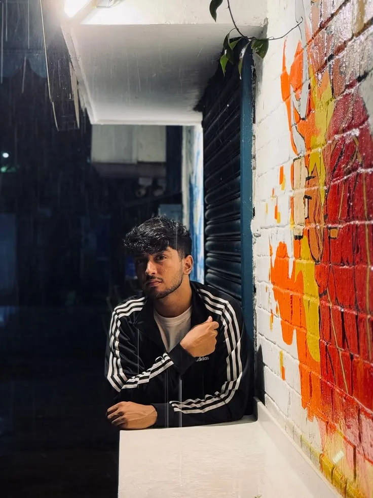 Moody Rainy Night Portrait of Young Man Leaning on White Ledge