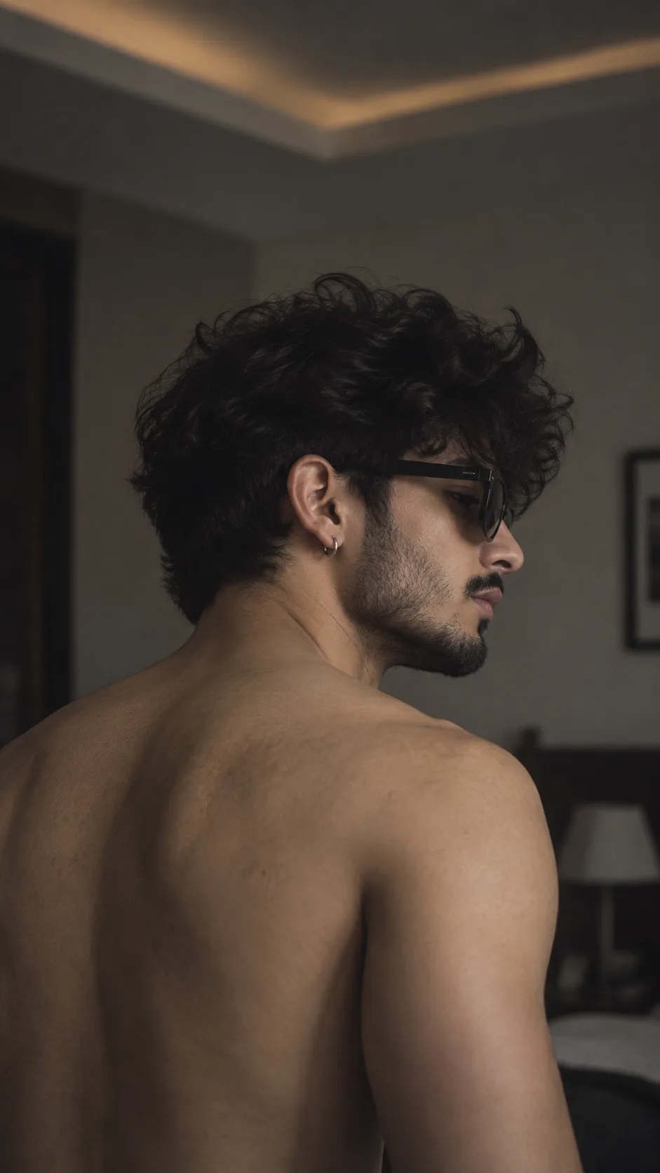A cinematic, moody, realistic indoor portrait of a young man in side profile facing right, captured from slightly behind, matching the