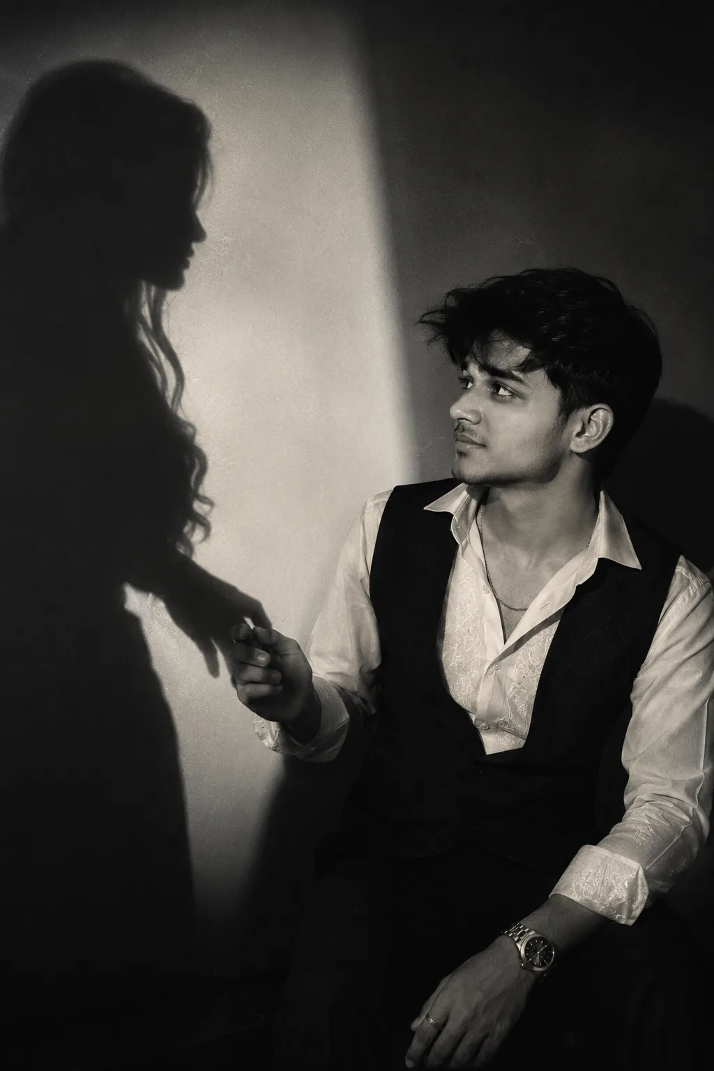A cinematic, moody black-and-white editorial photograph of the SAME boy from the uploaded reference image.