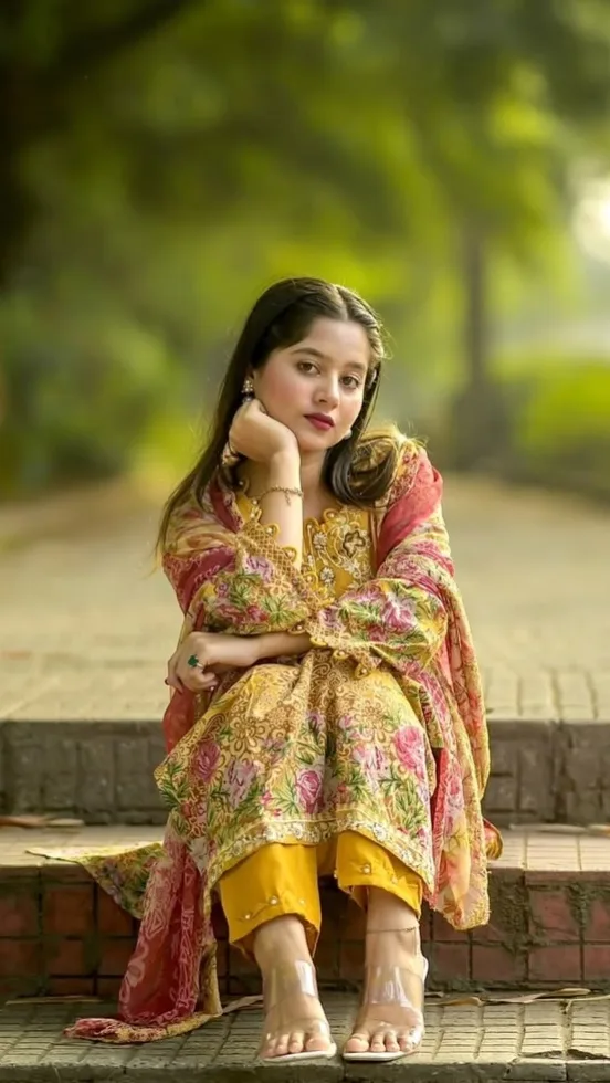 A photorealistic full-body vertical portrait of the young South Asian woman from the reference image, faithfully preserving her exact
