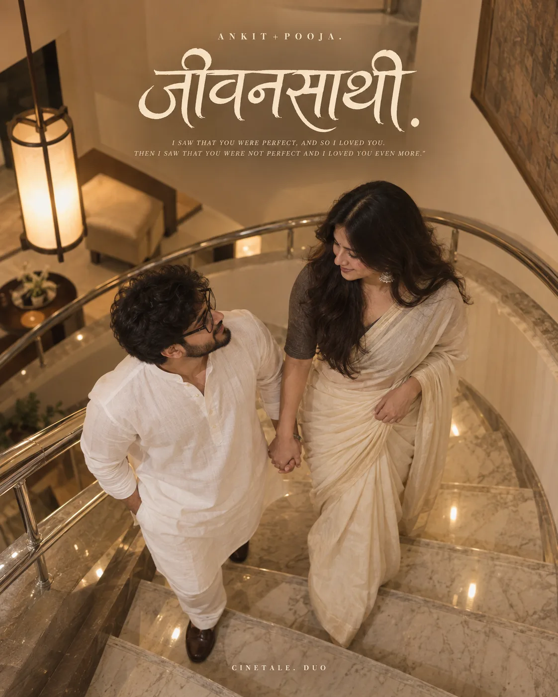 A HIGH-ANGLE INDOOR SHOT OF AN INDIAN COUPLE STANDING ON A MODERN CURVED STAIRCASE WITH POLISHED MARBLE STEPS AND A CURVED STAINLESS STEEL