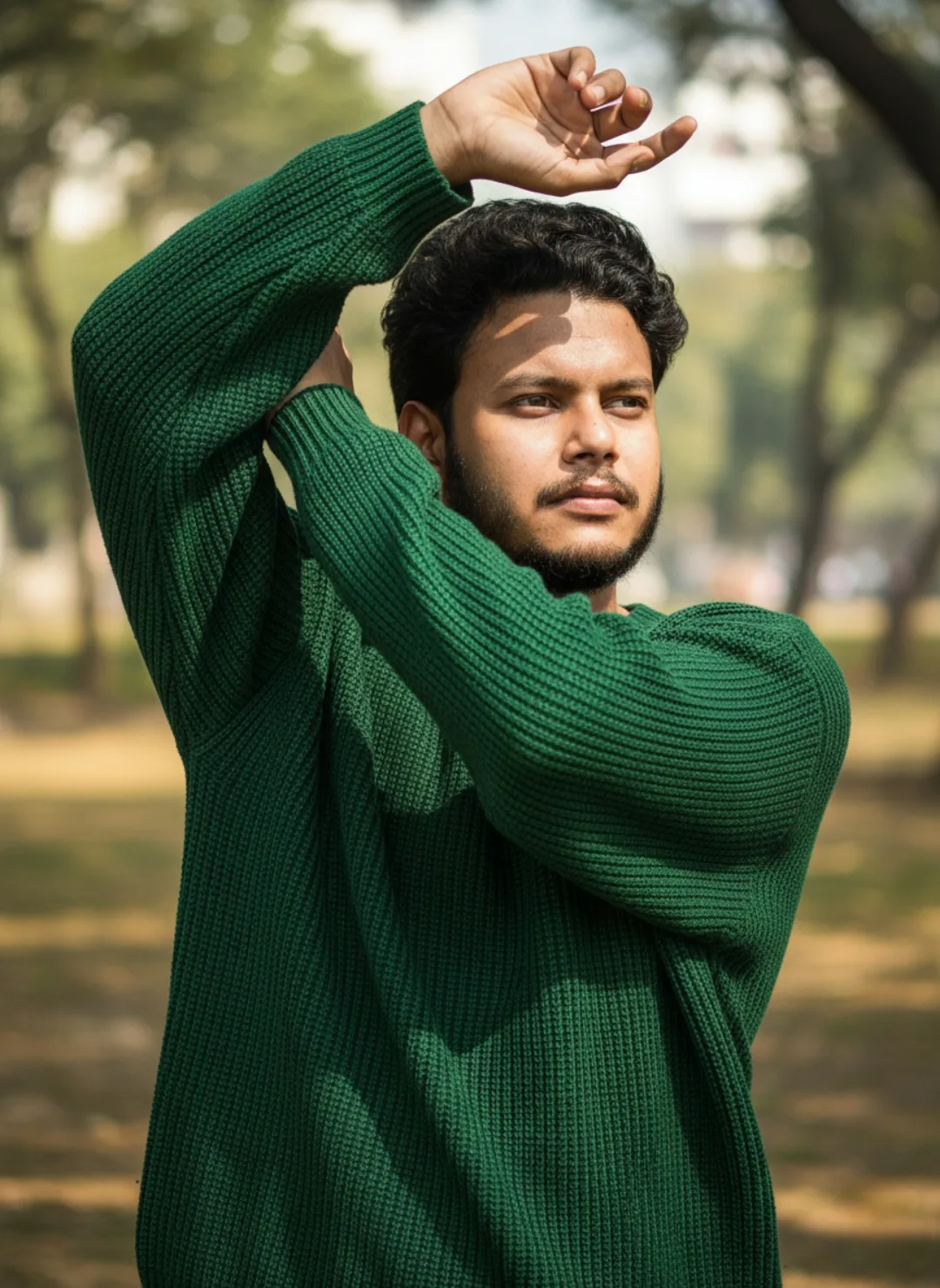 **Prompt:** A young South Asian man with curly dark hair, full beard, and mustache, wearing a textured dark green waffle-knit long-sleeve