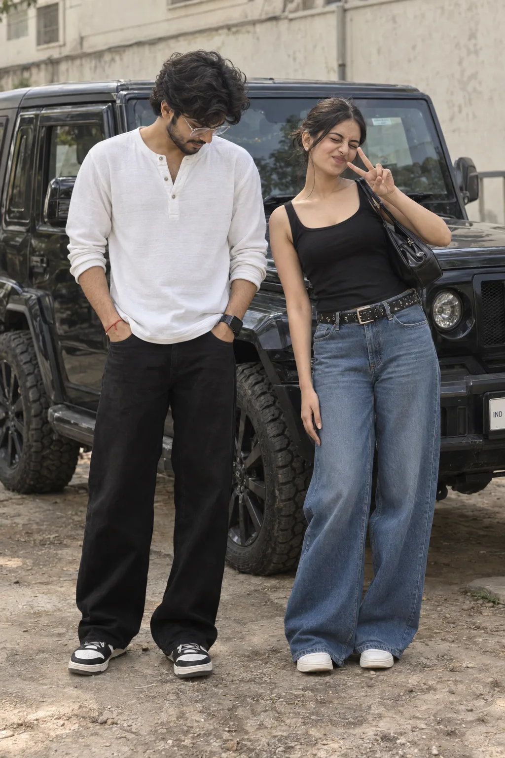 Ultra-realistic, photorealistic full-body portrait of a young Indian couple standing outdoors, positioned about one foot apart.
