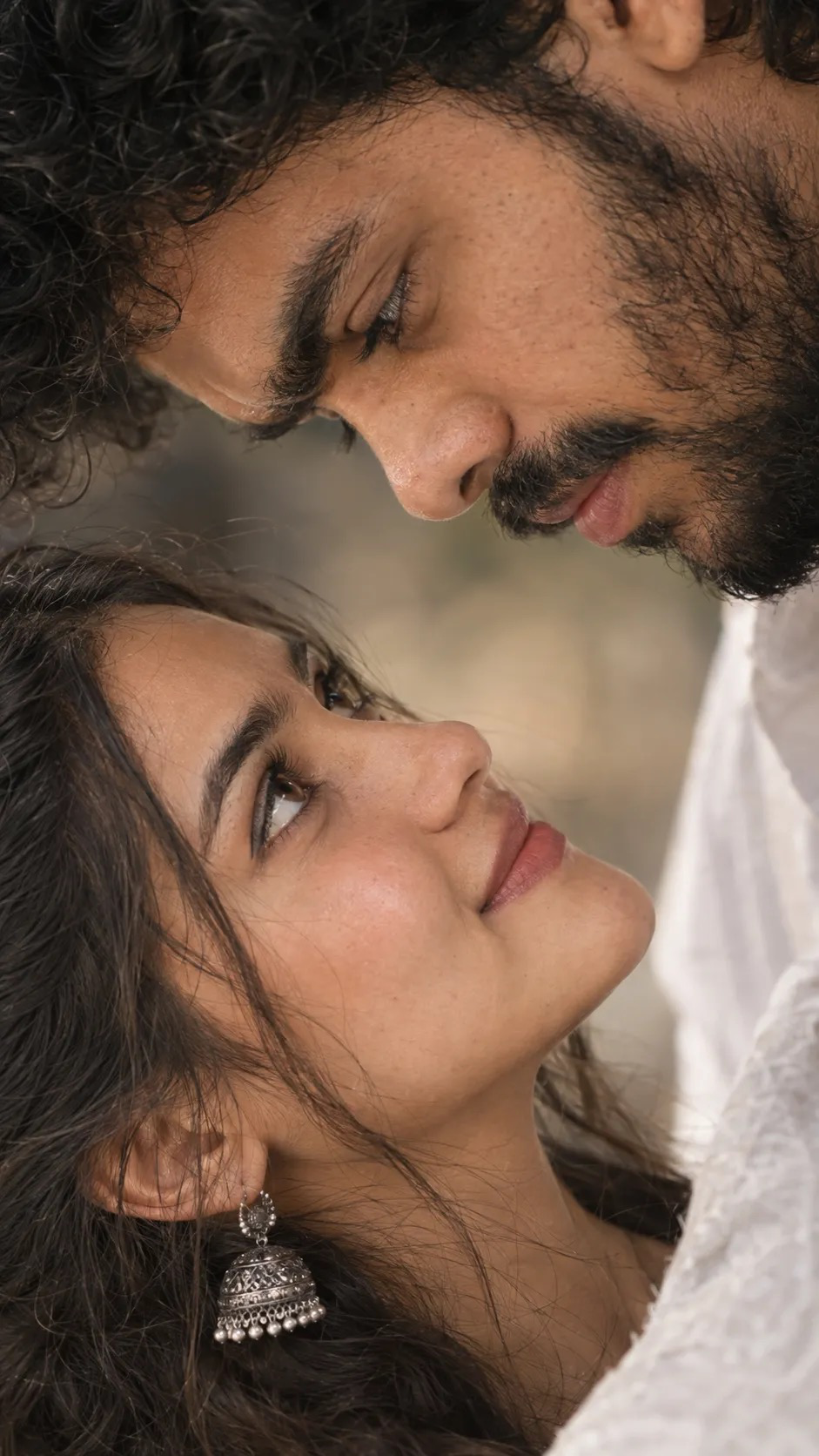 Create an ultra-realistic, highly detailed vertical 9:16 romantic close-up portrait of a young adult couple, inspired by the reference