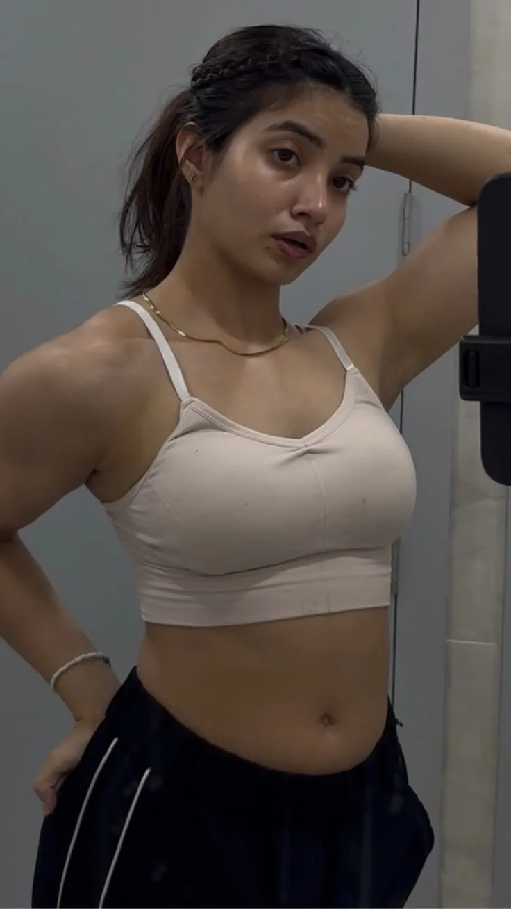 Create a photorealistic vertical 9:16 fitness mirror-selfie portrait using the uploaded images as visual references.