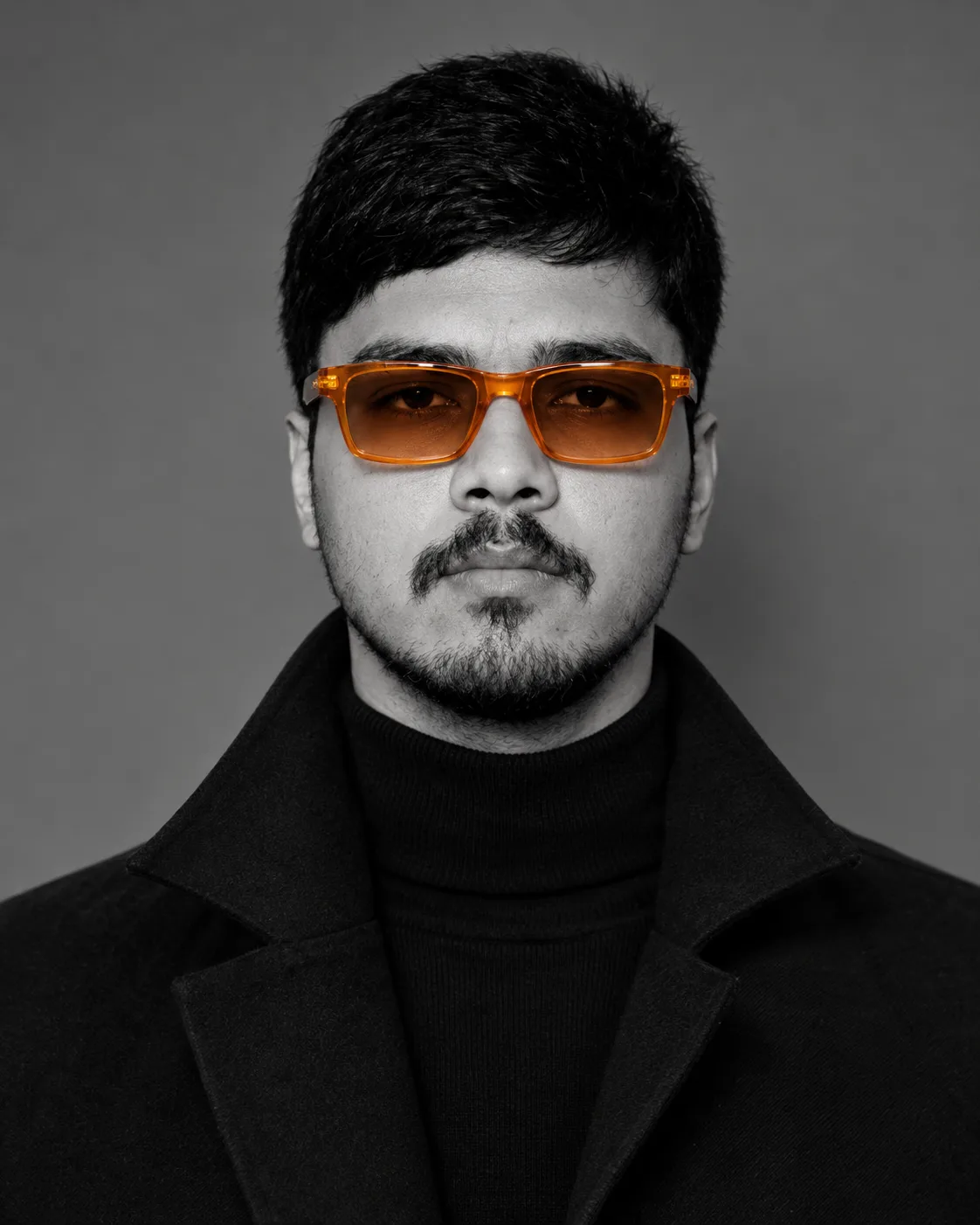 A studio-style close-up editorial portrait of a person with strong, well-defined facial features and slightly imperfect, natural skin