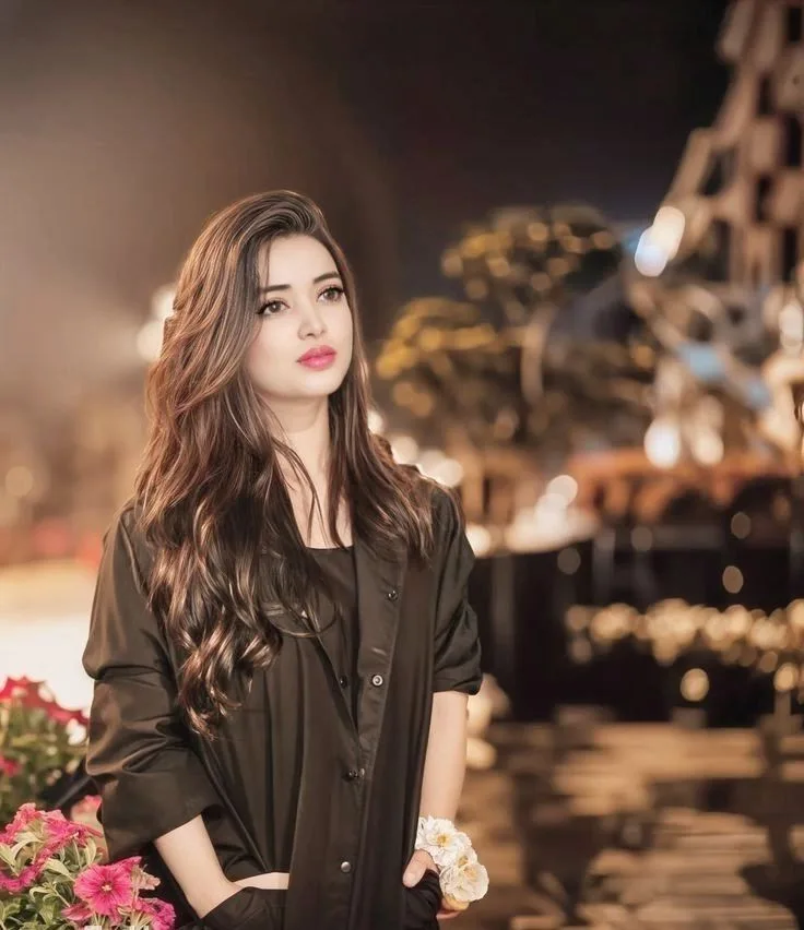A beautiful medium shot of a stunning young woman with long, voluminous, and wavy light brown hair cascading down her shoulders.