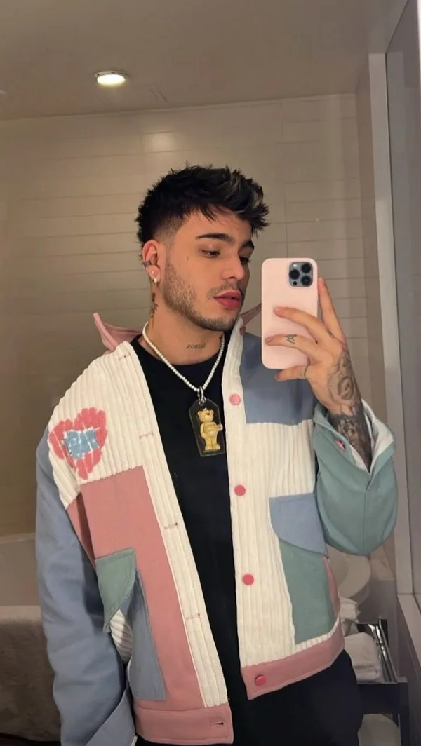 A photorealistic vertical medium shot of the young man from the reference image, faithfully preserving his exact recognizable facial