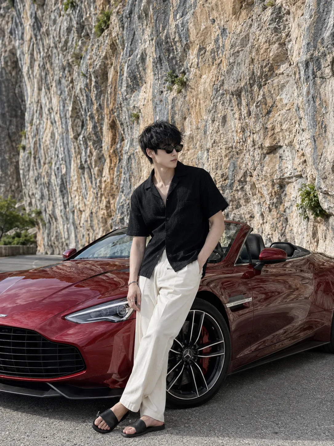 Create an **ultra-realistic, premium luxury automotive travel-fashion photograph of a stylish young male traveler casually leaning against