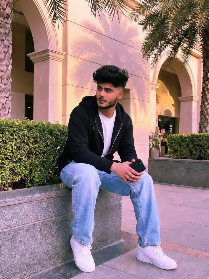 A photorealistic vertical full-length shot of the young South Asian man from the reference image, faithfully preserving his recognizable