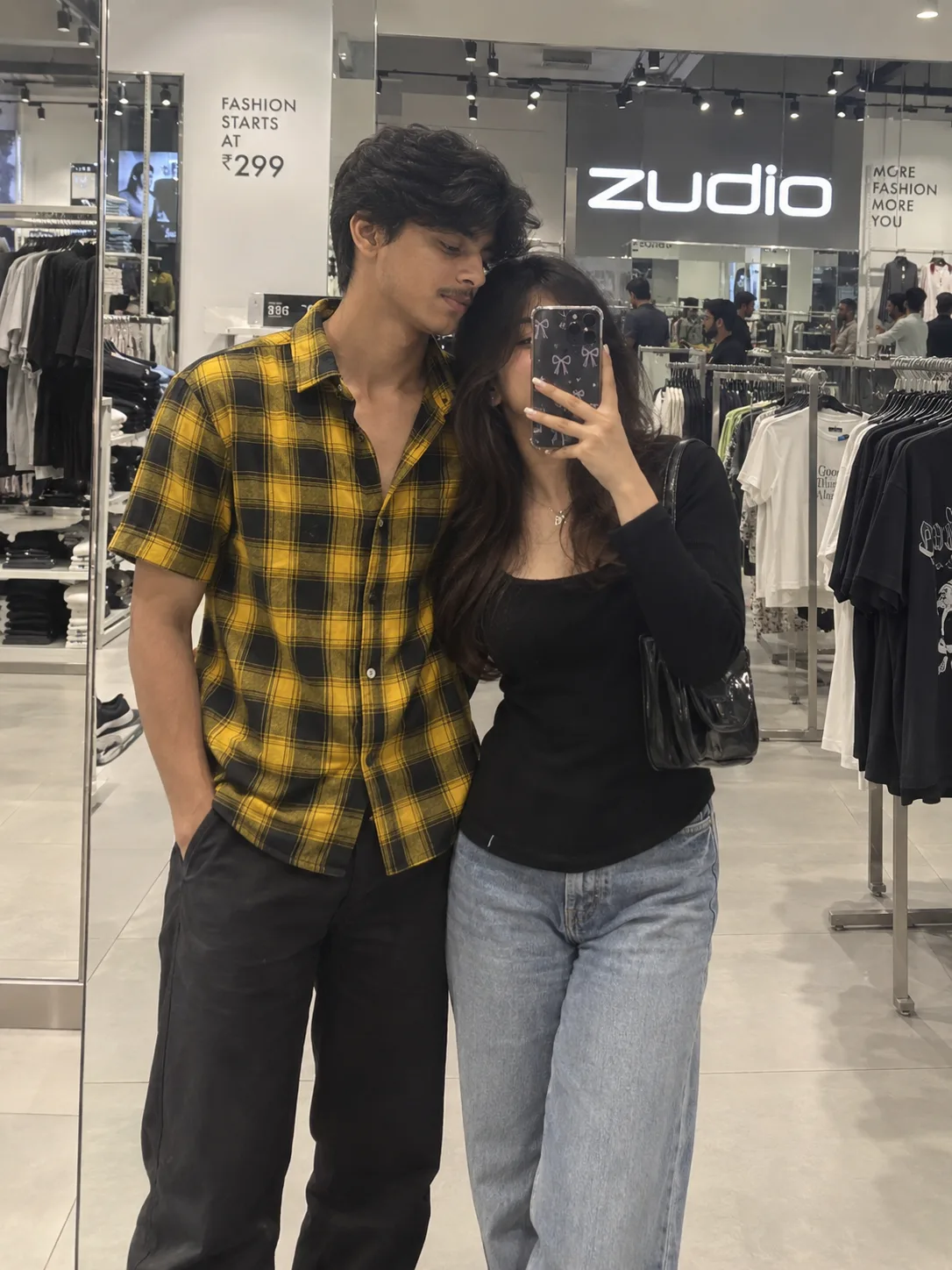 Modify the background to a modern clothing store like Zudio with large glass mirrors, clothing racks, and bright store lighting.