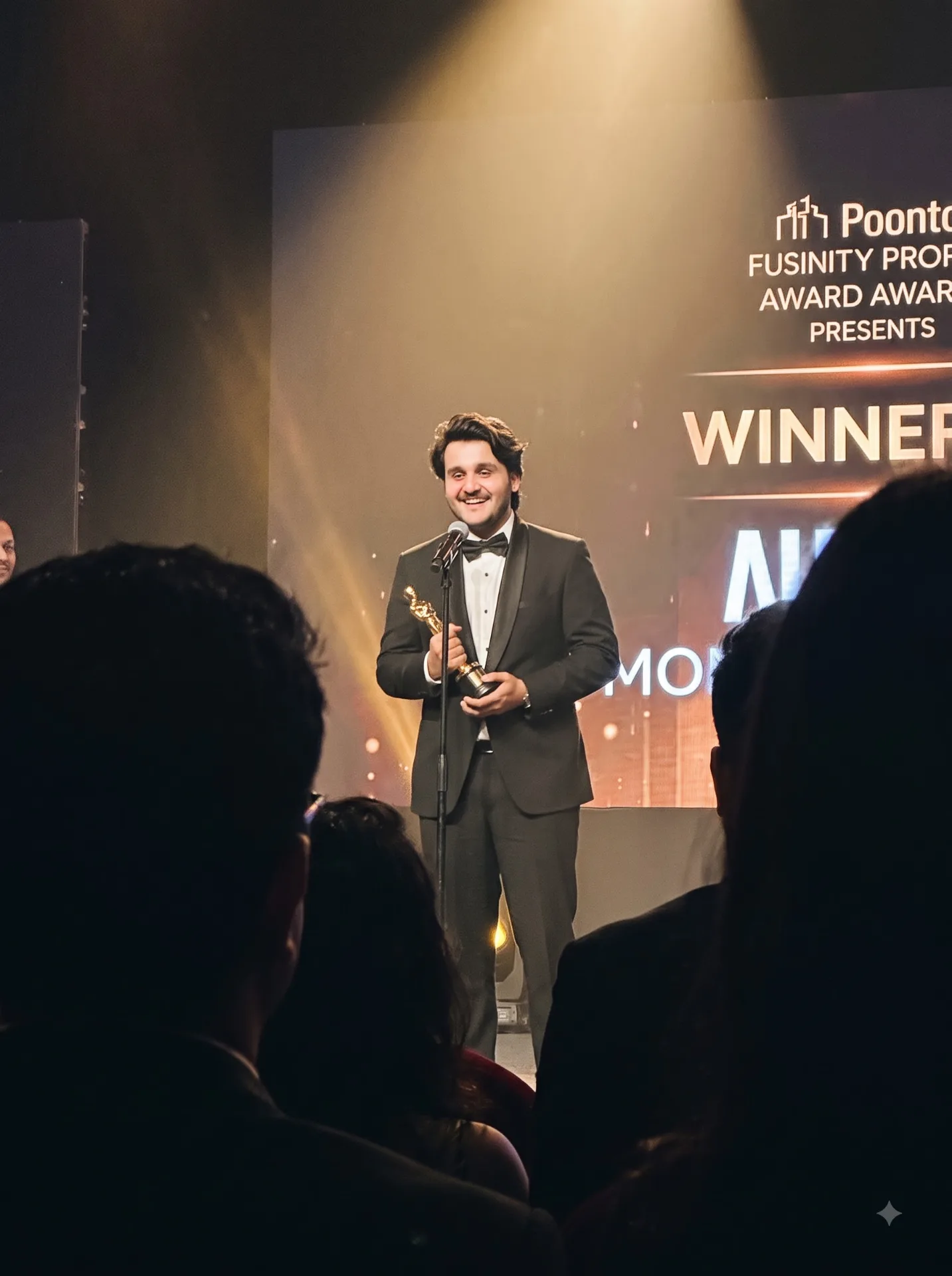 A candid photo shot from a seat deep in the audience on a phone at a major awards ceremony.