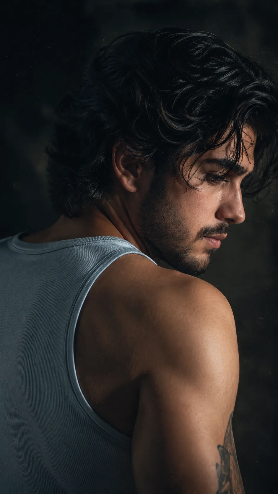A highly cinematic, photorealistic close-up portrait of a ruggedly handsome young adult man shown from behind in a dramatic three-quarter