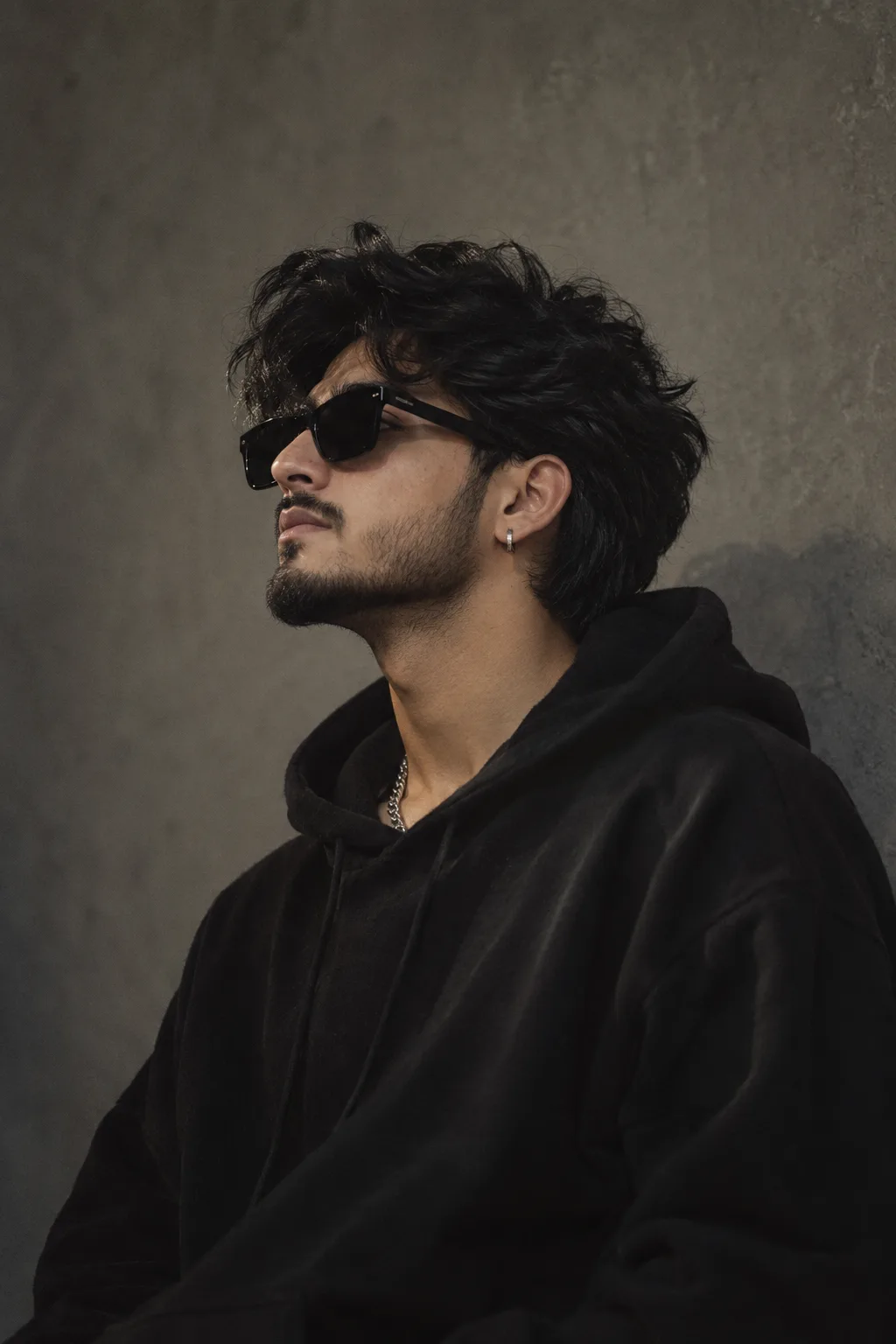 A cinematic, moody, realistic portrait photo of a stylish young man in the same pose and composition as the reference image, side profile