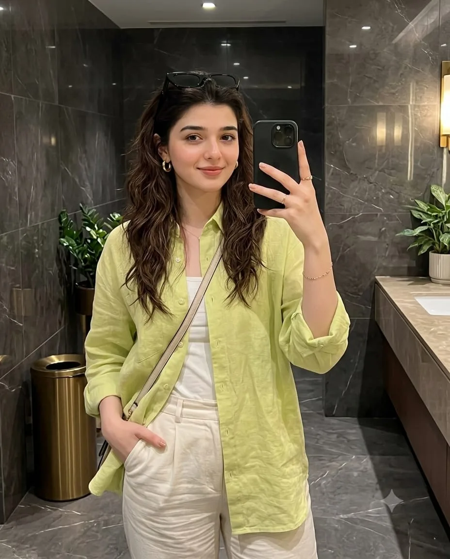 A mirror selfie photo of the subject from the reference image, maintaining her exact facial features, hair, and appearance.