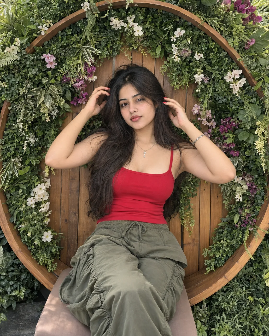 Create an ultra-realistic, high-resolution vertical lifestyle fashion photograph of a young adult South Asian woman reclining/seated.