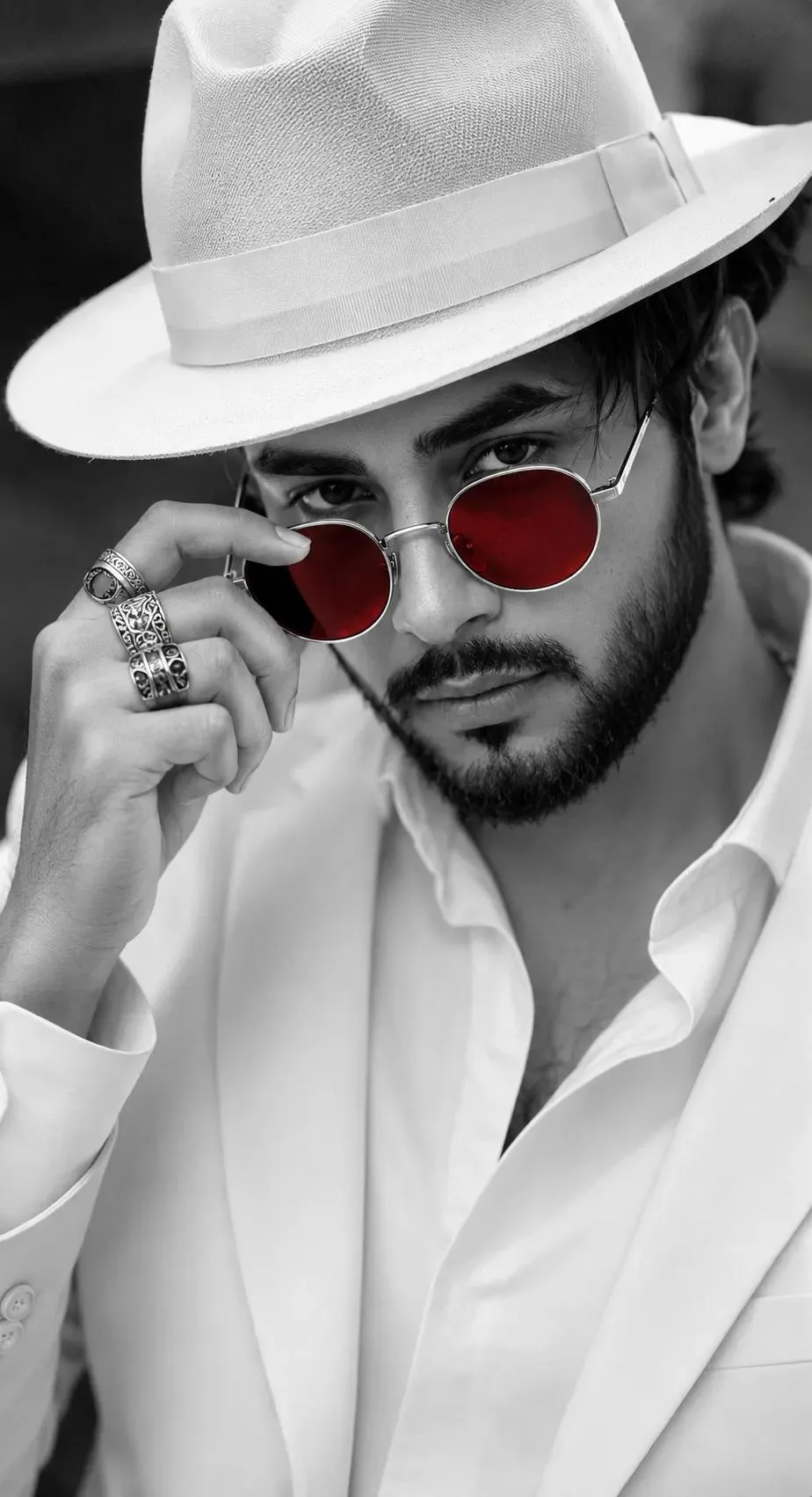 "A close-up, selective-color fashion portrait of a handsome man with a short beard and mustache.