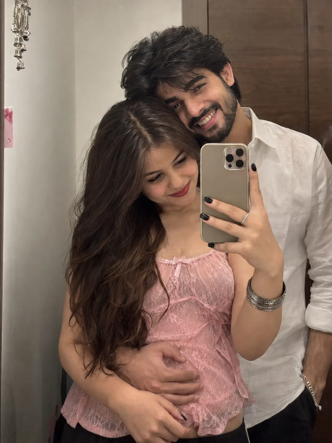 A hyper-realistic, 8k resolution, raw photorealistic mirror selfie of a young couple, waist-up mid-shot framing.