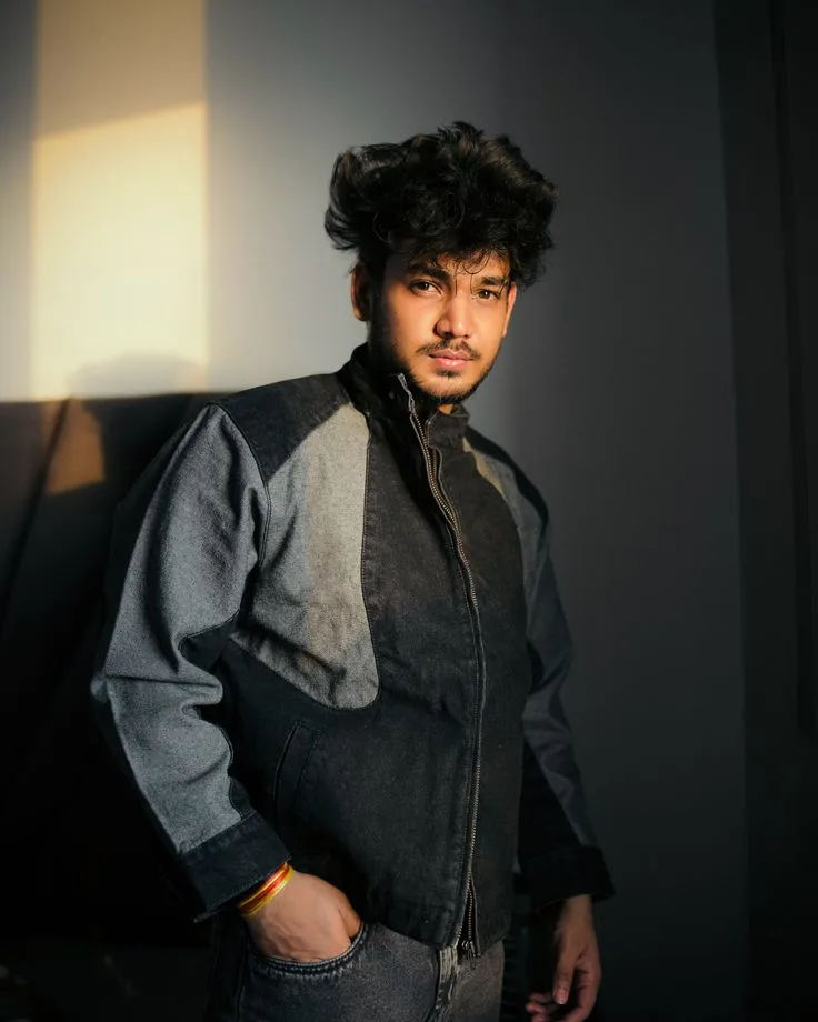 Dramatic Golden Hour Indoor Portrait of Young Indian Man in Color-Blocked Jacket