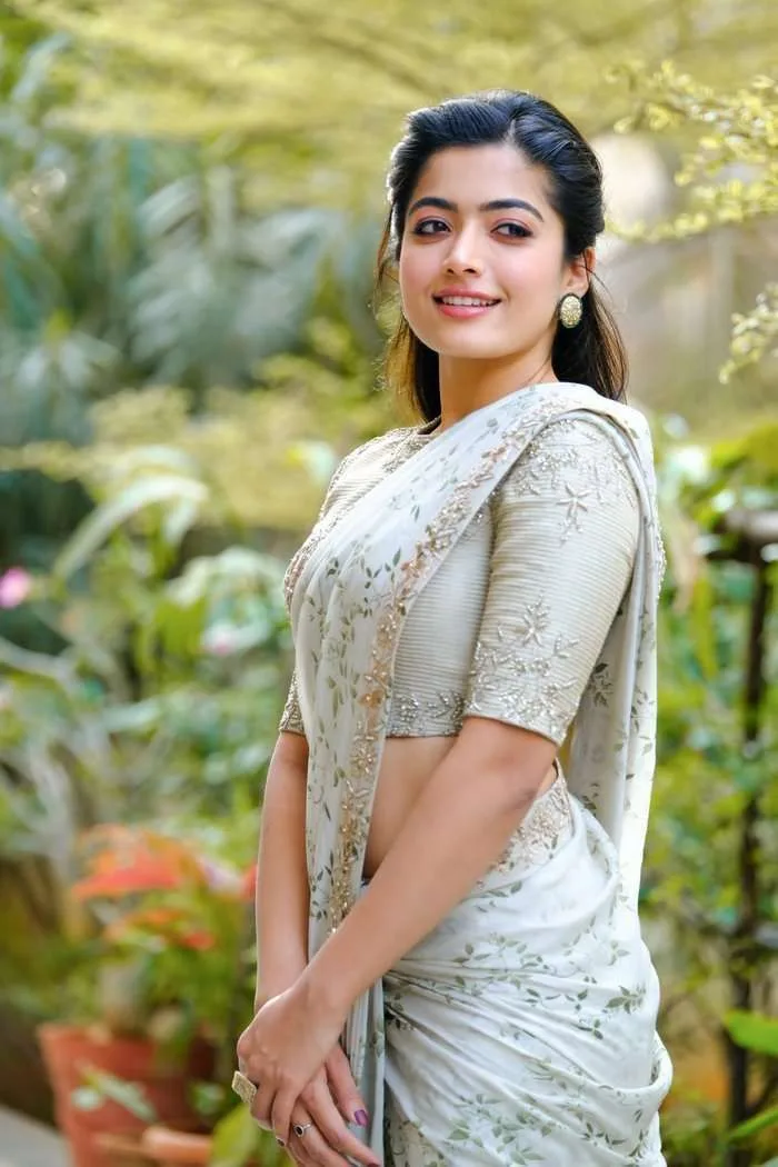 { "category": "fashion_editorial", "category_reasoning": "Styled celebrity portrait in traditional Indian designer attire with deliberate