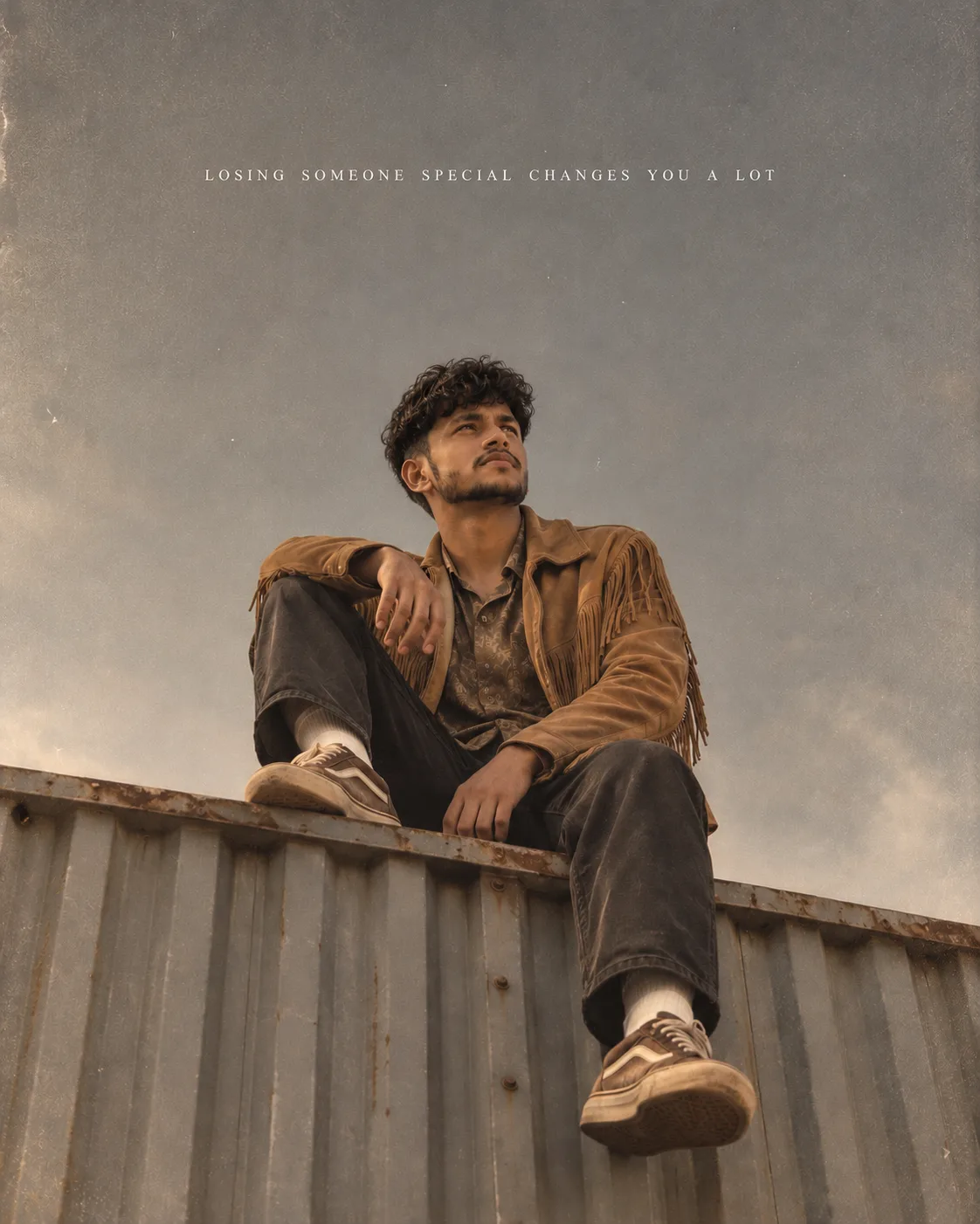 Minimalist vintage cinematic poster of a young man sitting alone on the edge of a corrugated industrial rooftop, photographed from a