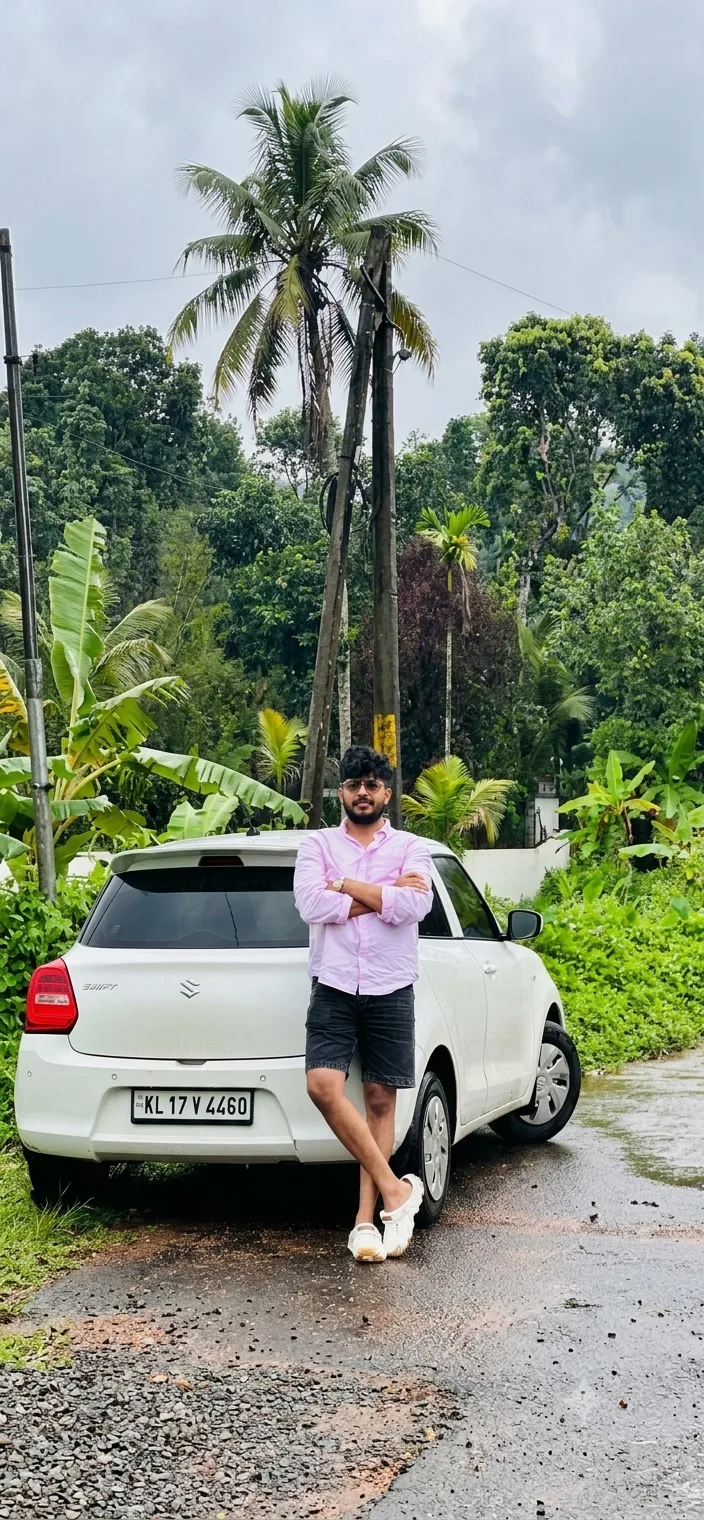 A photorealistic vertical full-length shot capturing the young South Asian man from the reference image standing on a wet country road in