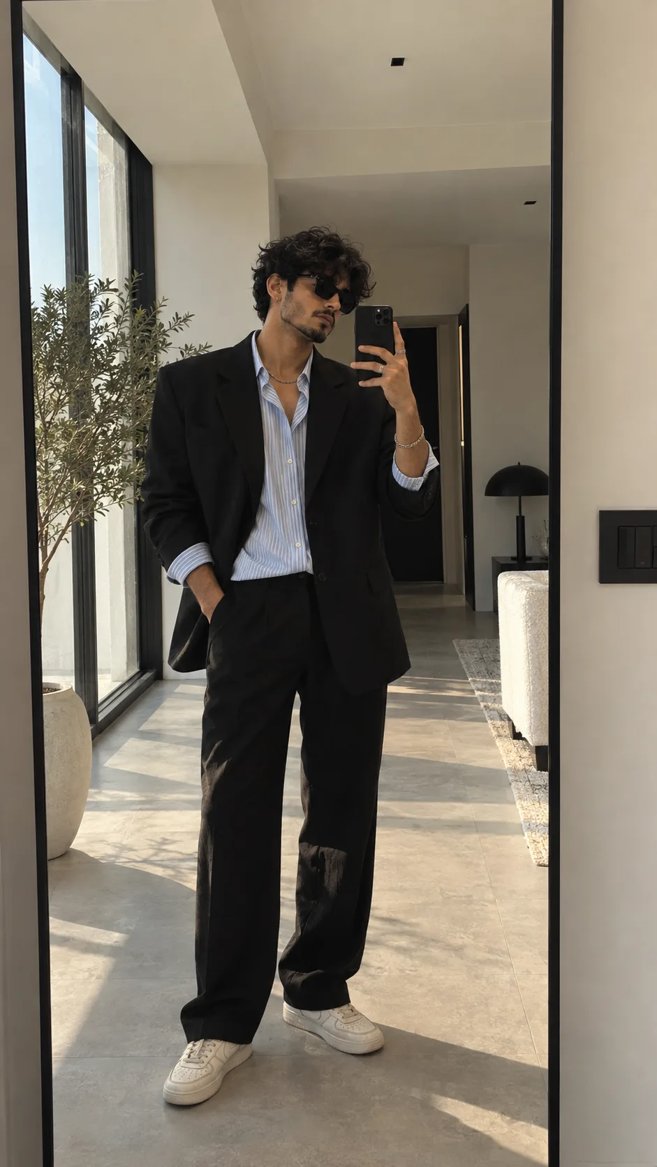 Ultra-photorealistic premium mirror selfie portrait of a stylish man standing in front of a large vertical wall mirror in a bright