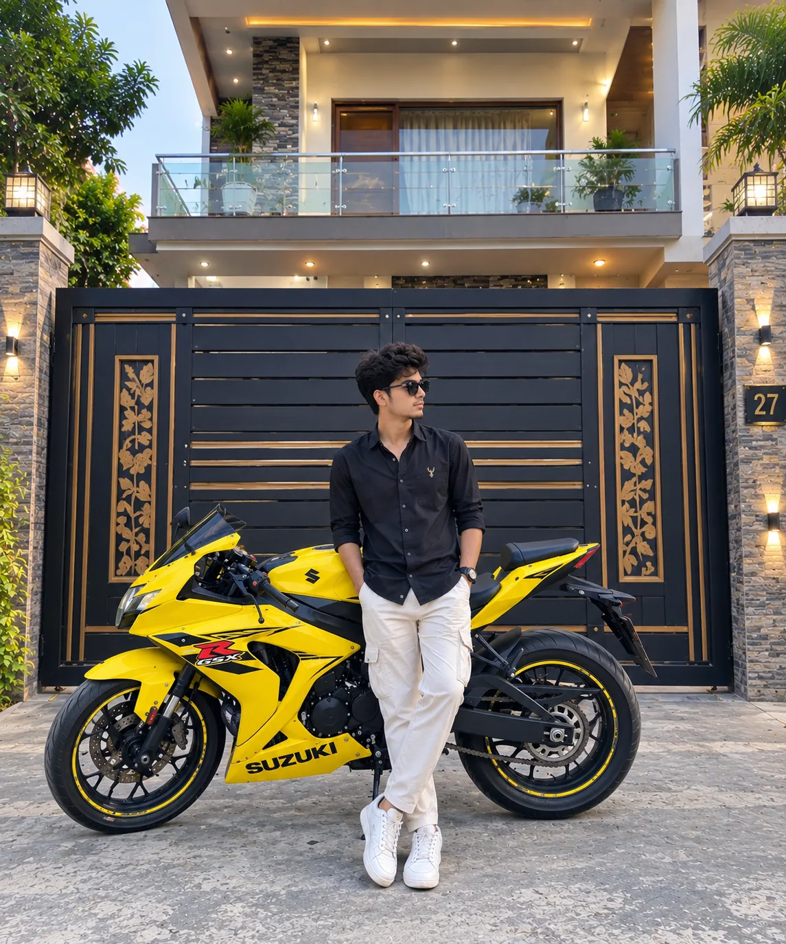A stylish young man wearing a premium black outfit, sunglasses, and white sneakers stands confidently in front of a bright yellow Suzuki