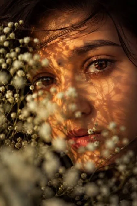 [Extreme close-up portrait of a young South Asian woman, focusing closely on her expressive brown eyes.