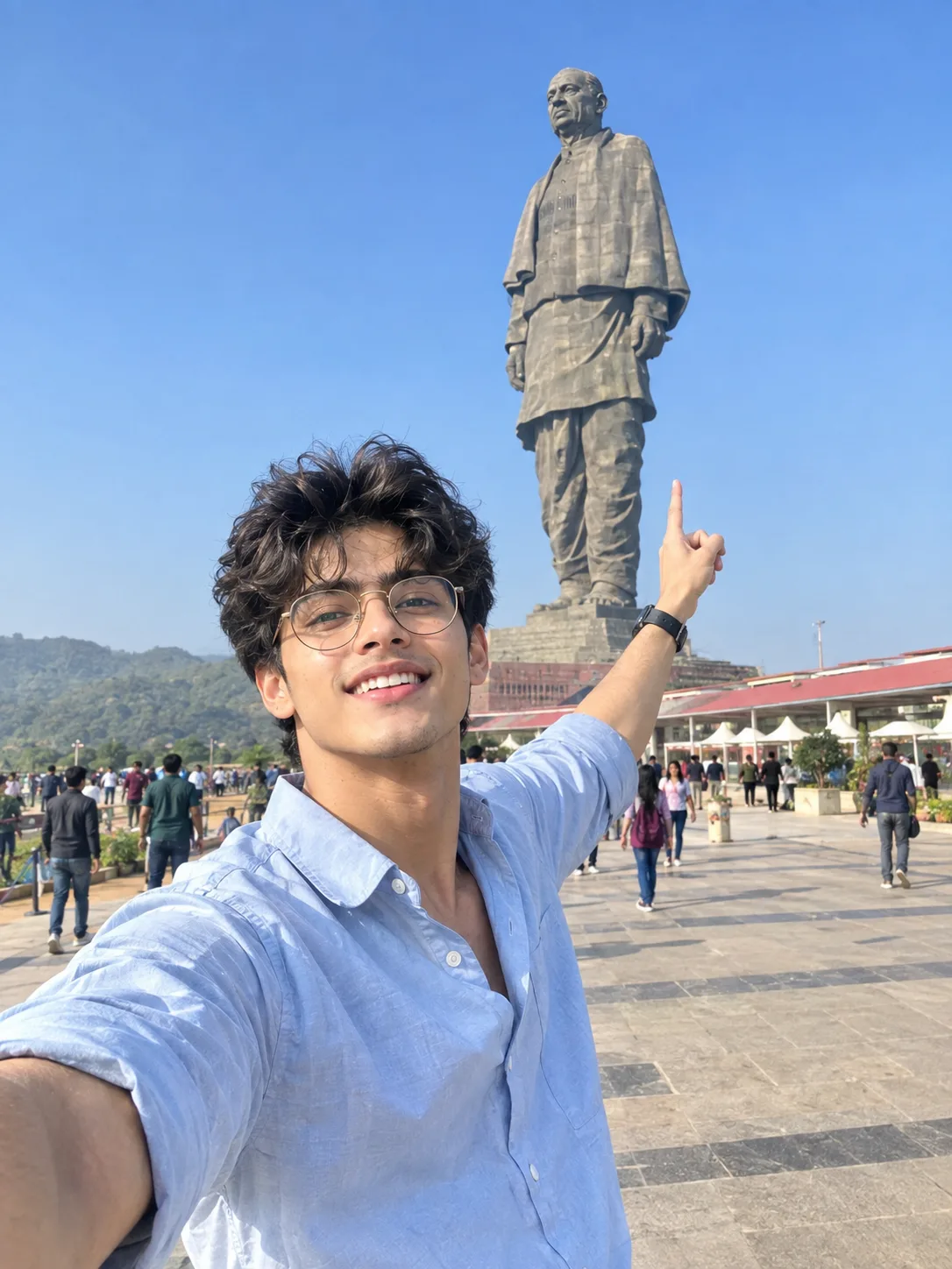 Cheerful Young Man Taking a Selfie in Front of the Statue of Unity