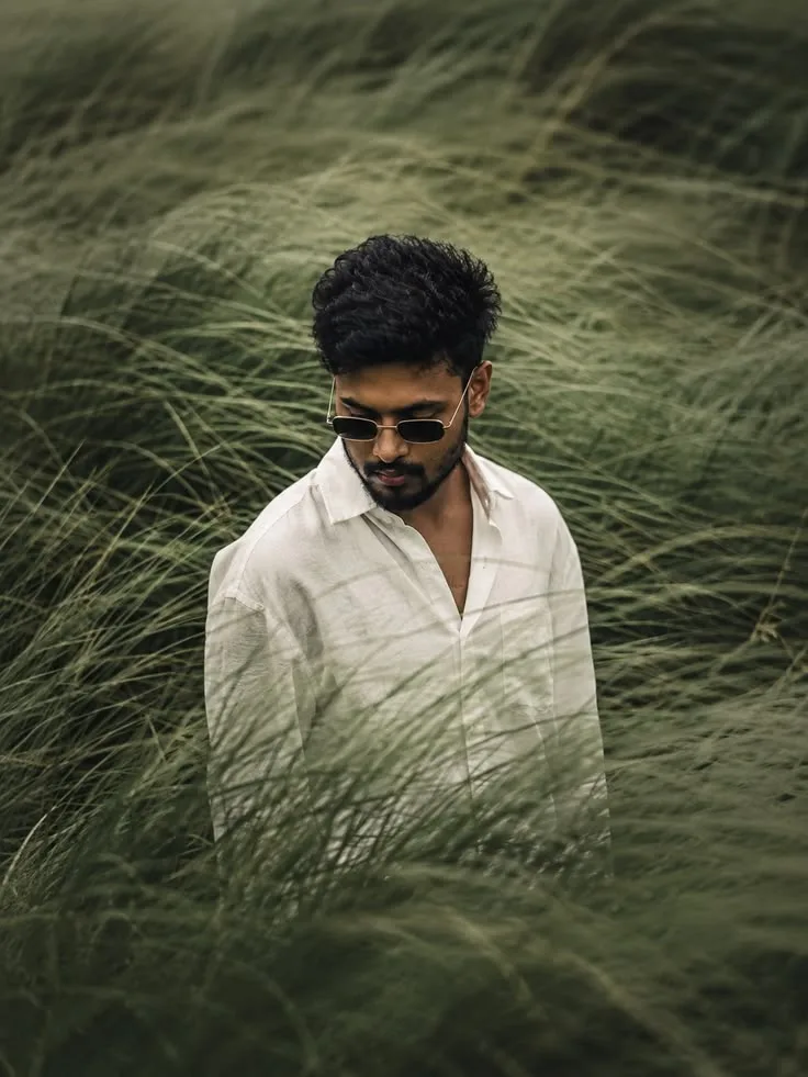 Moody Overcast Portrait of Young Indian Man in Tall Grass Field