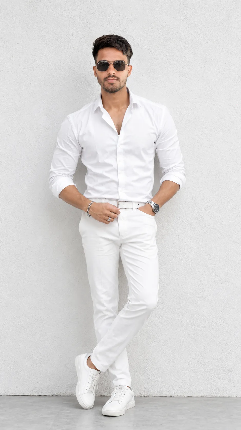 Create a highly realistic full-body fashion portrait of a stylish young South Asian/Indian man standing confidently against a clean