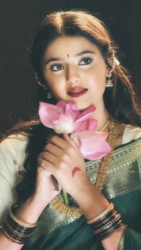 A vintage cinematic close-up portrait of a beautiful young South Asian woman in a classic 1990s film aesthetic.