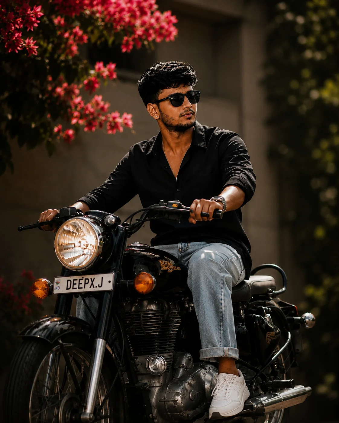 Ultra-realistic cinematic full-body photograph of a stylish young South Asian man sitting confidently on a classic black Royal Enfield
