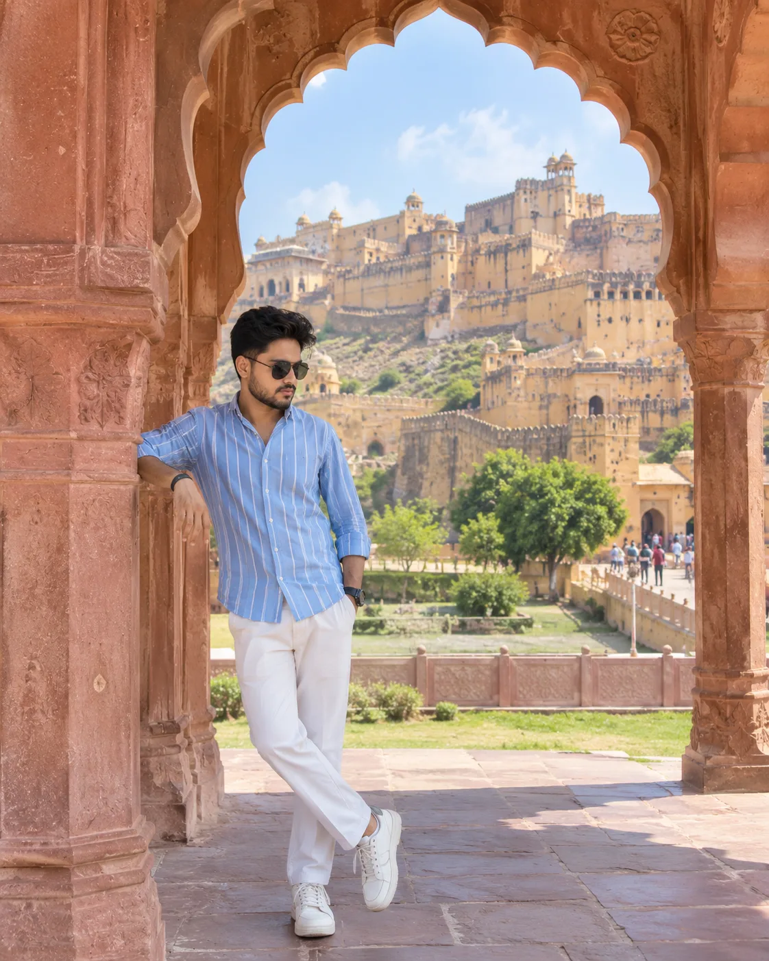📸 Prompt: Create a highly realistic, ultra-detailed cinematic travel photograph of a young Indian man casually posing at Amer Fort (Amber