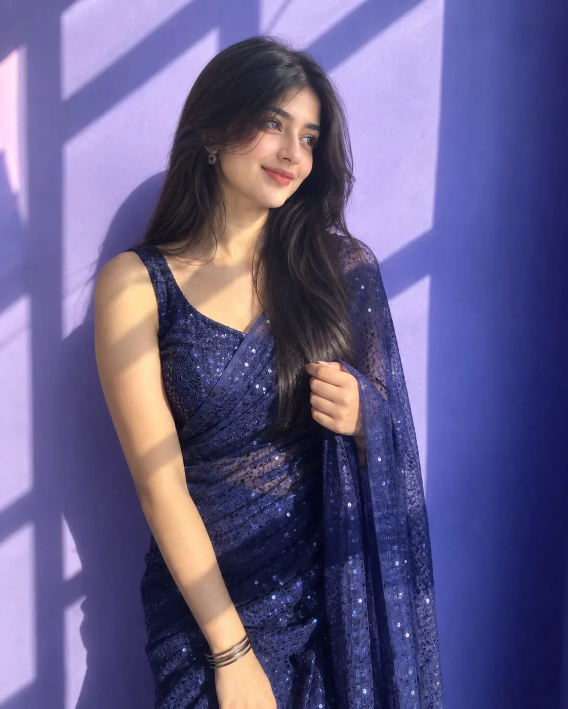 Create an ultra-realistic, high-detail vertical 4:5 portrait of a young South Asian woman wearing an elegant deep navy-blue sequined saree