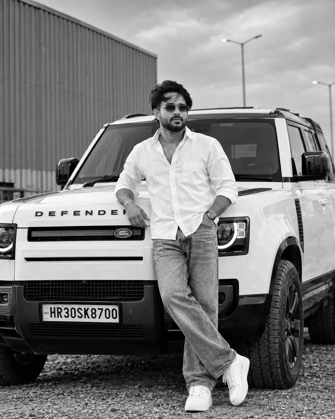 Create a highly realistic cinematic black-and-white luxury fashion portrait using my uploaded photo as the exact face reference.