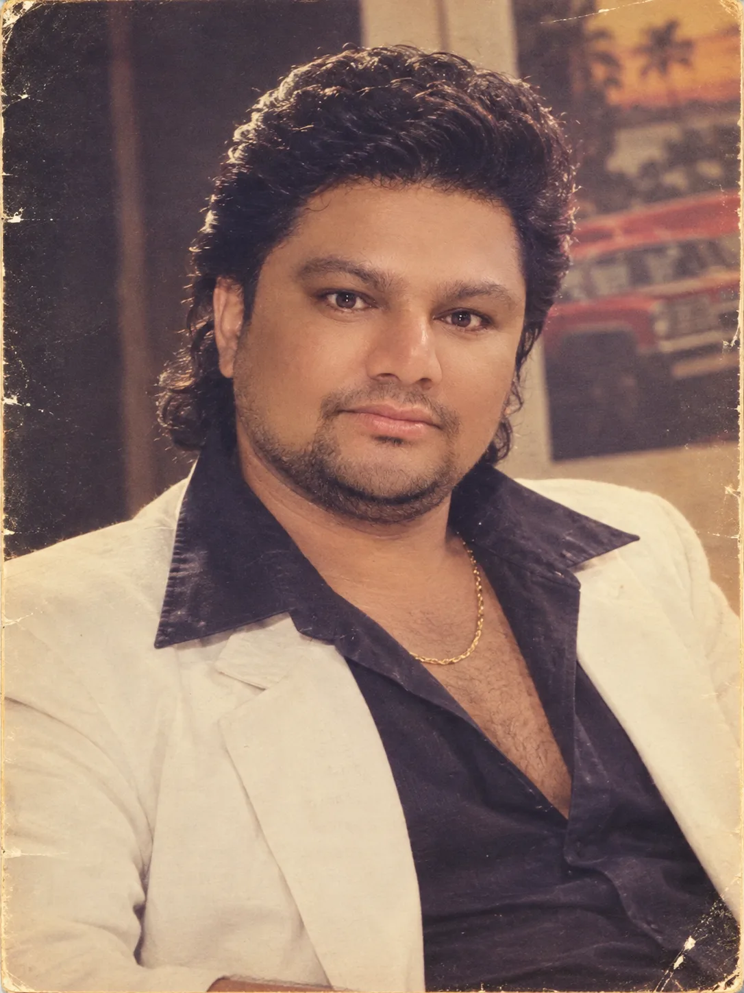 Authentic 1980s vintage Indian studio portrait of the same man, preserving his exact facial features, identity, face shape, eyes, nose,