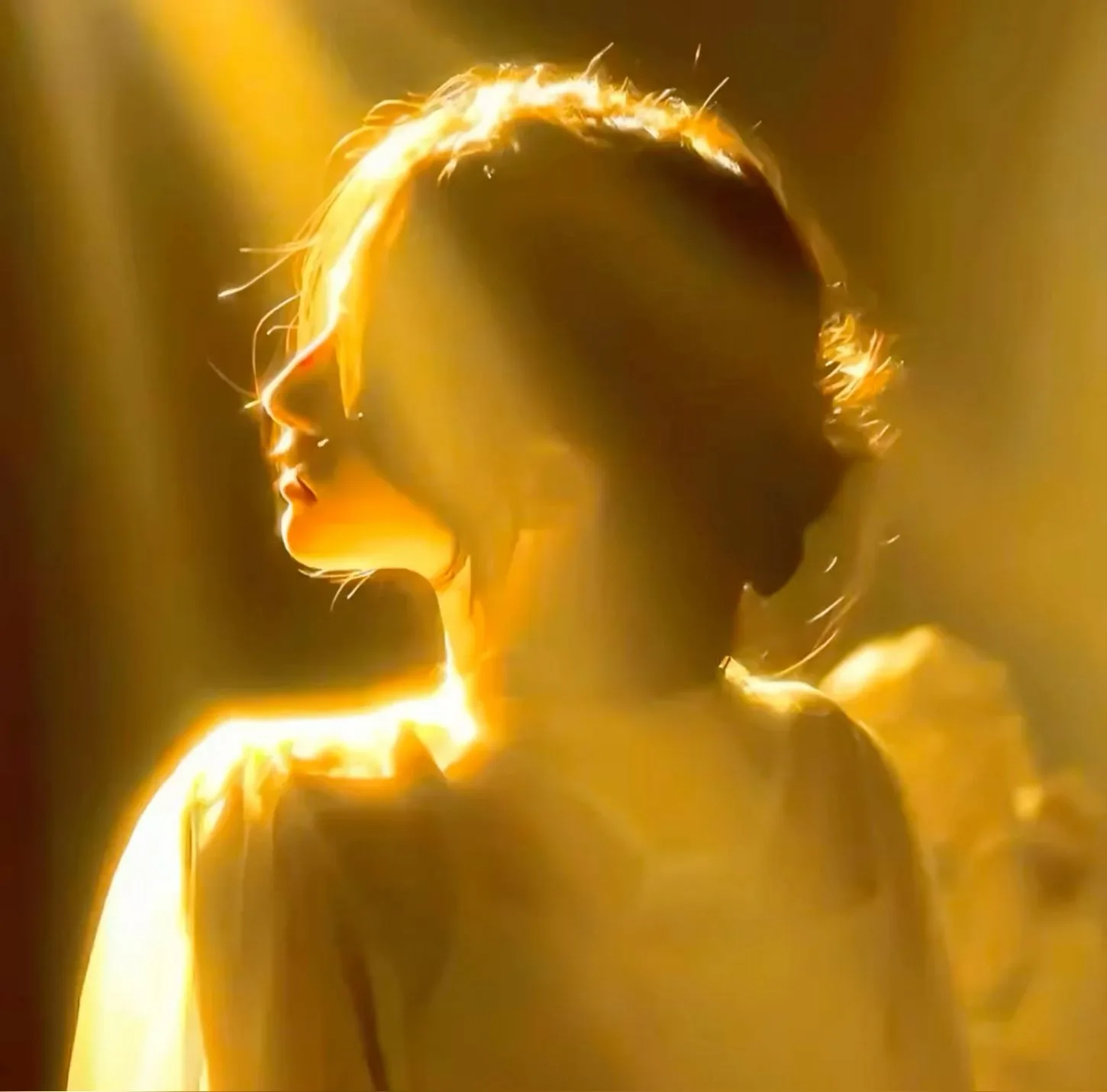 A dreamy and ethereal cinematic portrait of a young woman seen from the side profile, drenched in intense golden light.