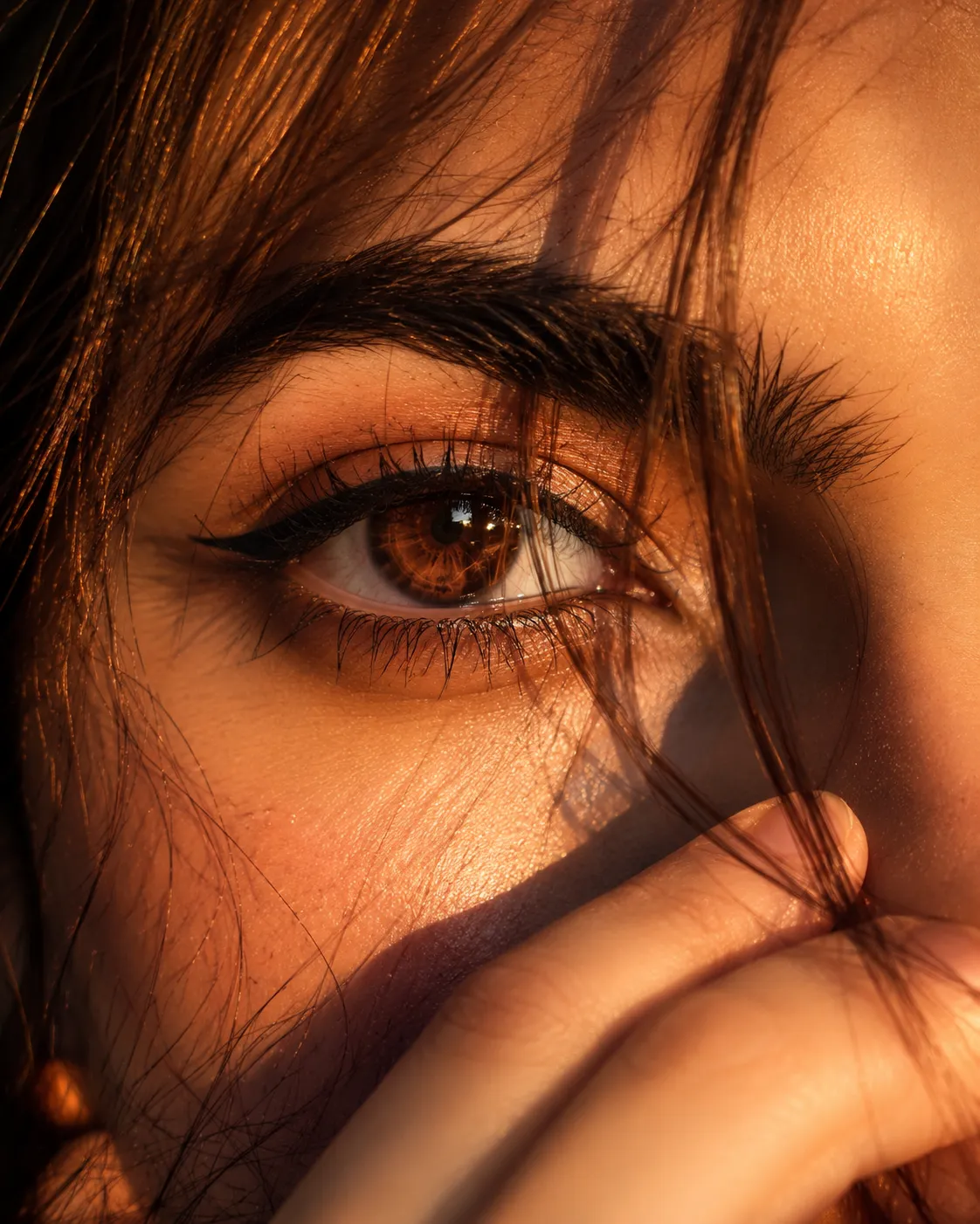 Ultra-realistic cinematic extreme close-up portrait of a young woman’s single eye filling most of the frame, captured in warm golden-hour
