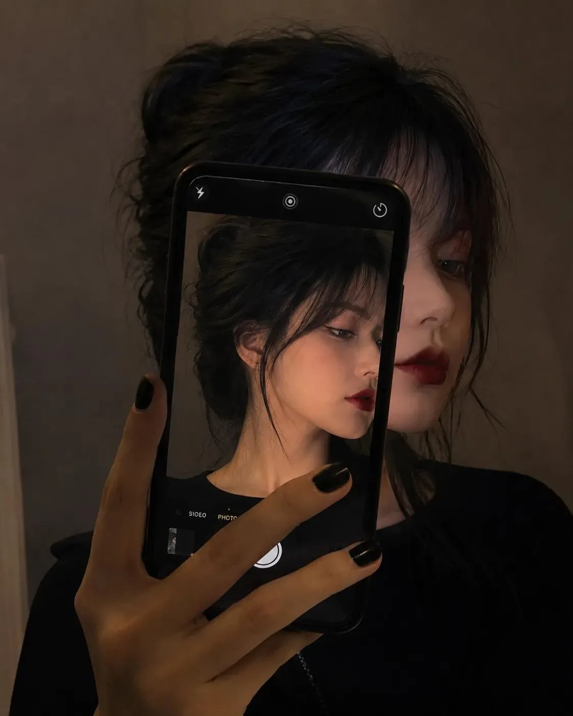 A highly realistic cinematic portrait of a beautiful young adult South Asian woman holding a black smartphone vertically in front of her
