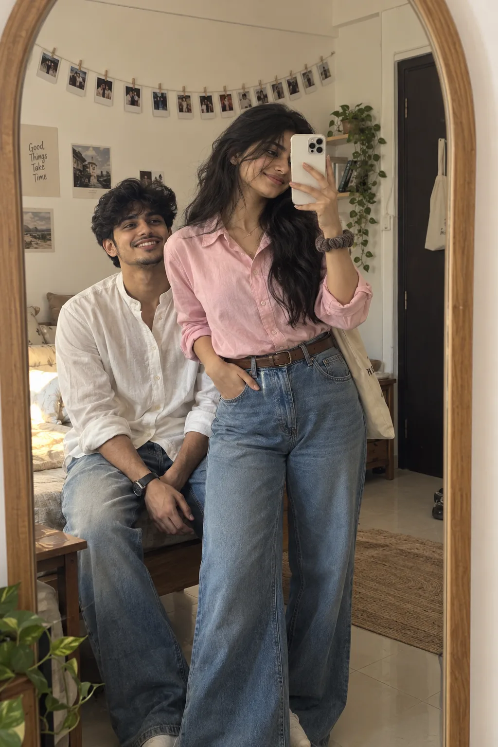 A hyper-realistic full-length mirror s elfie of a young South Asian couple in a cozy apartment room.