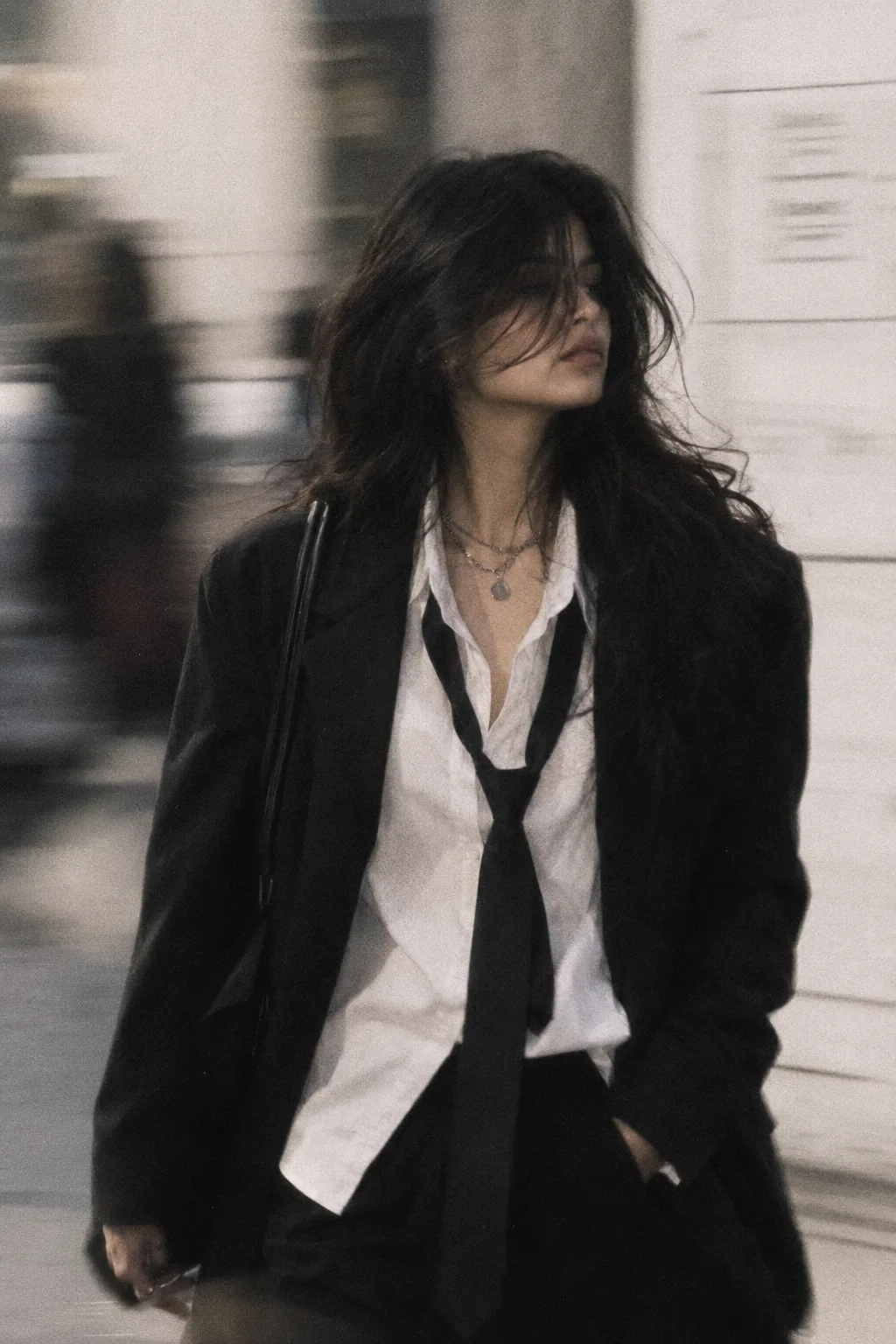 young woman, same face as reference, messy voluminous dark hair, soft texture, slightly covering eyes, sharp cheekbones, androgynous