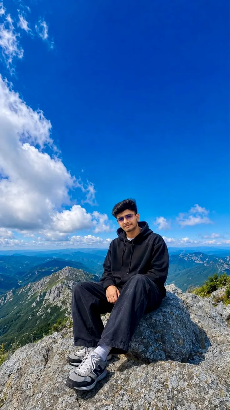 A photorealistic vertical full-length shot of the young South Asian man from the reference image, faithfully preserving his exact