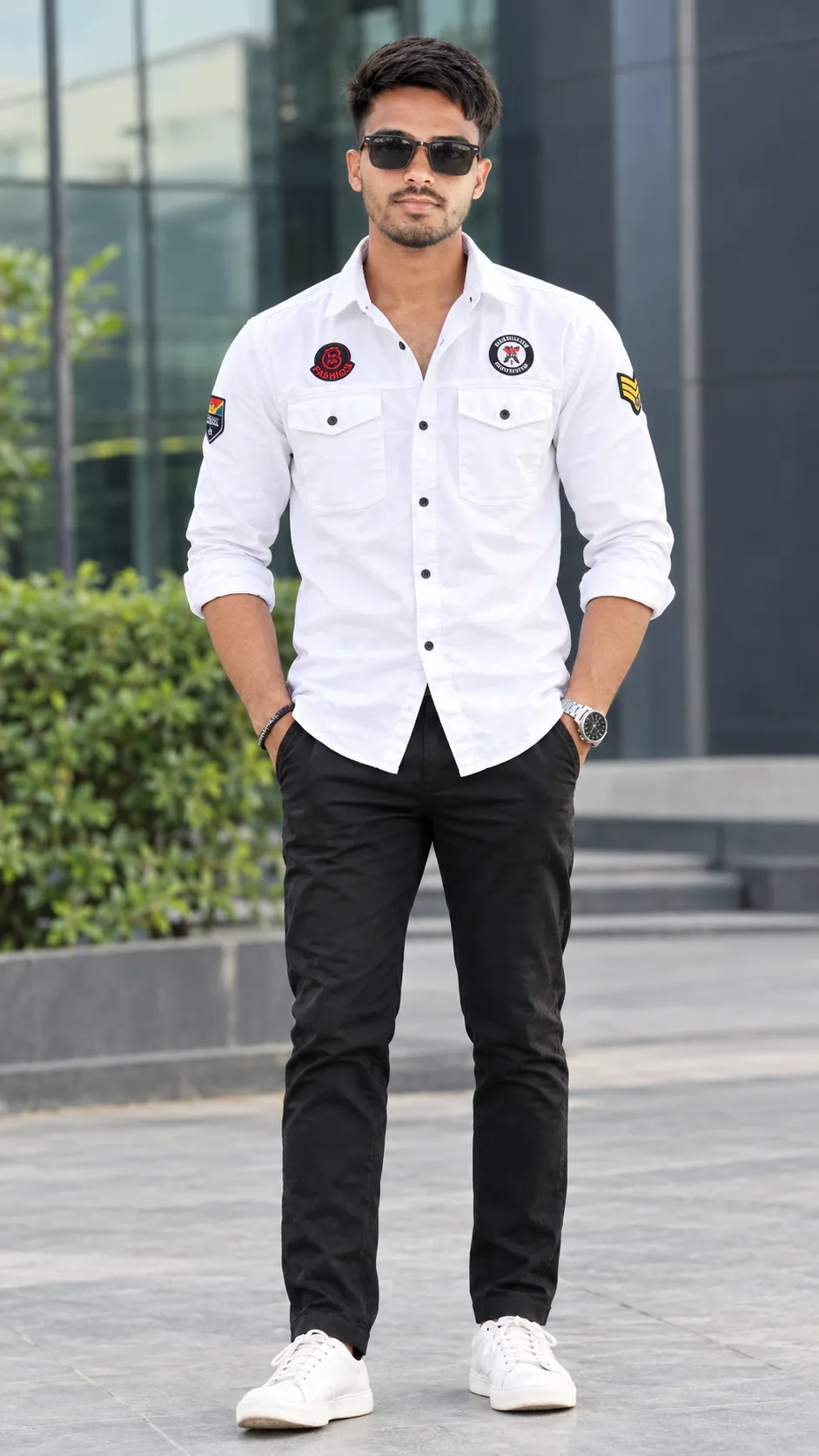 Create a highly realistic full-body fashion portrait of a stylish young South Asian/Indian man standing confidently outdoors in front of a