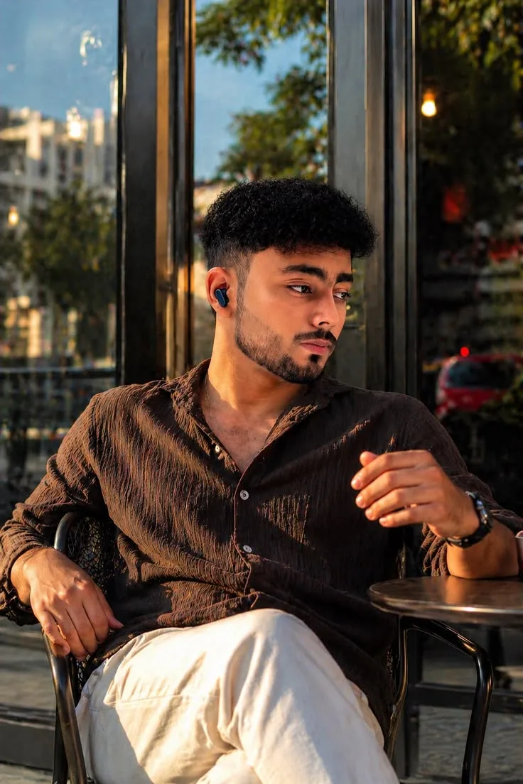 A photorealistic, candid medium-shot portrait of the young man from image_6.png, preserving his exact face and features.