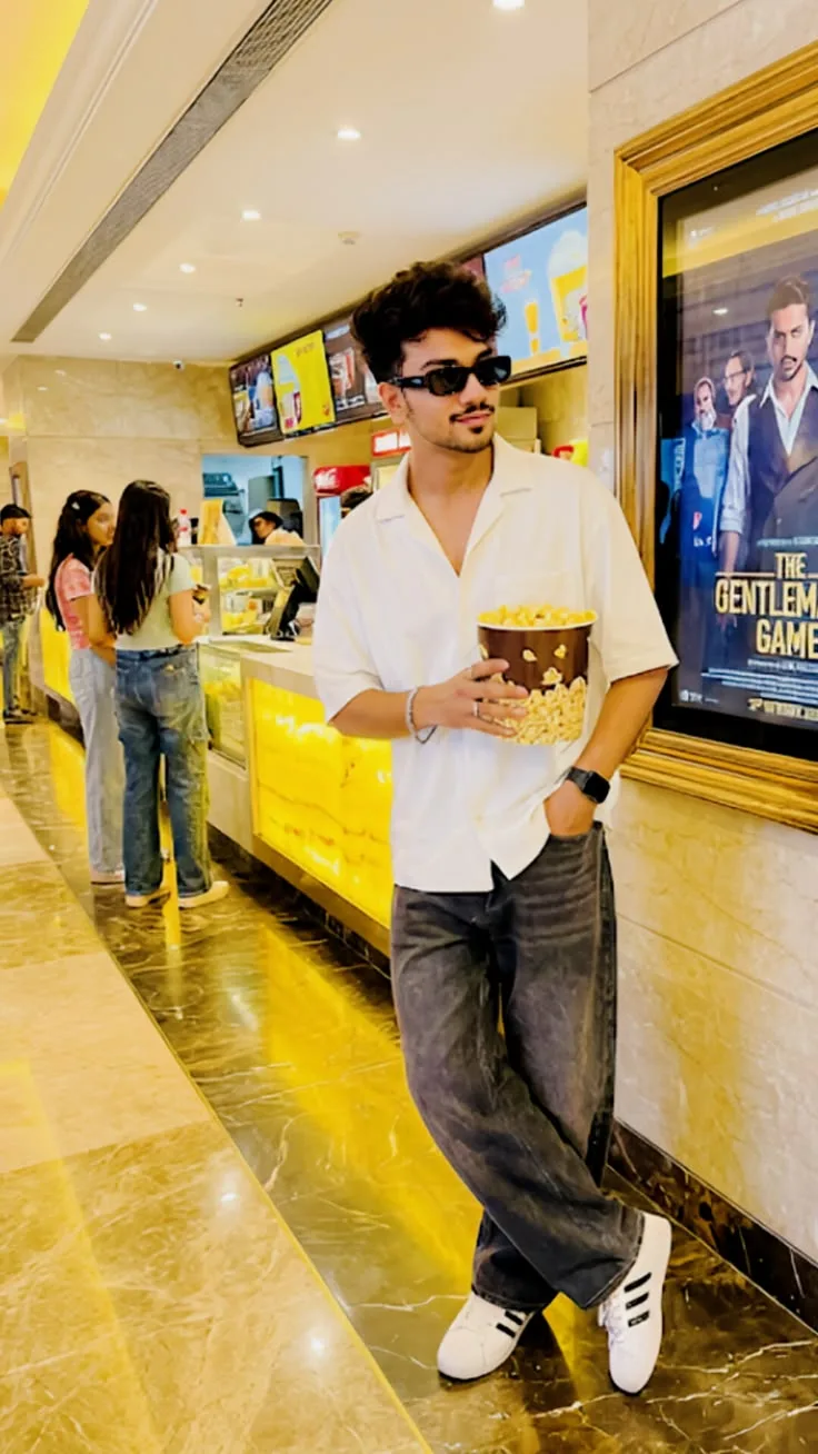 A photorealistic full-body vertical portrait of the young South Asian man from the reference image, faithfully preserving his exact