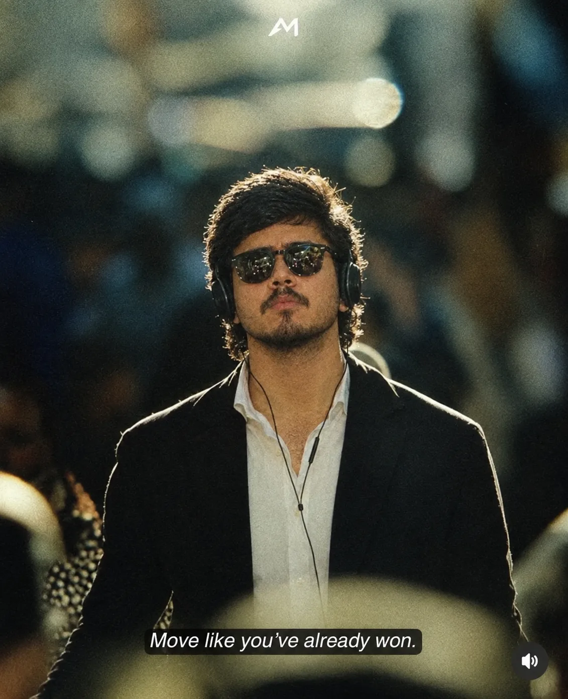 Create a cinematic luxury fashion portrait of a young man standing confidently in the center of a crowded, dimly lit urban environment.