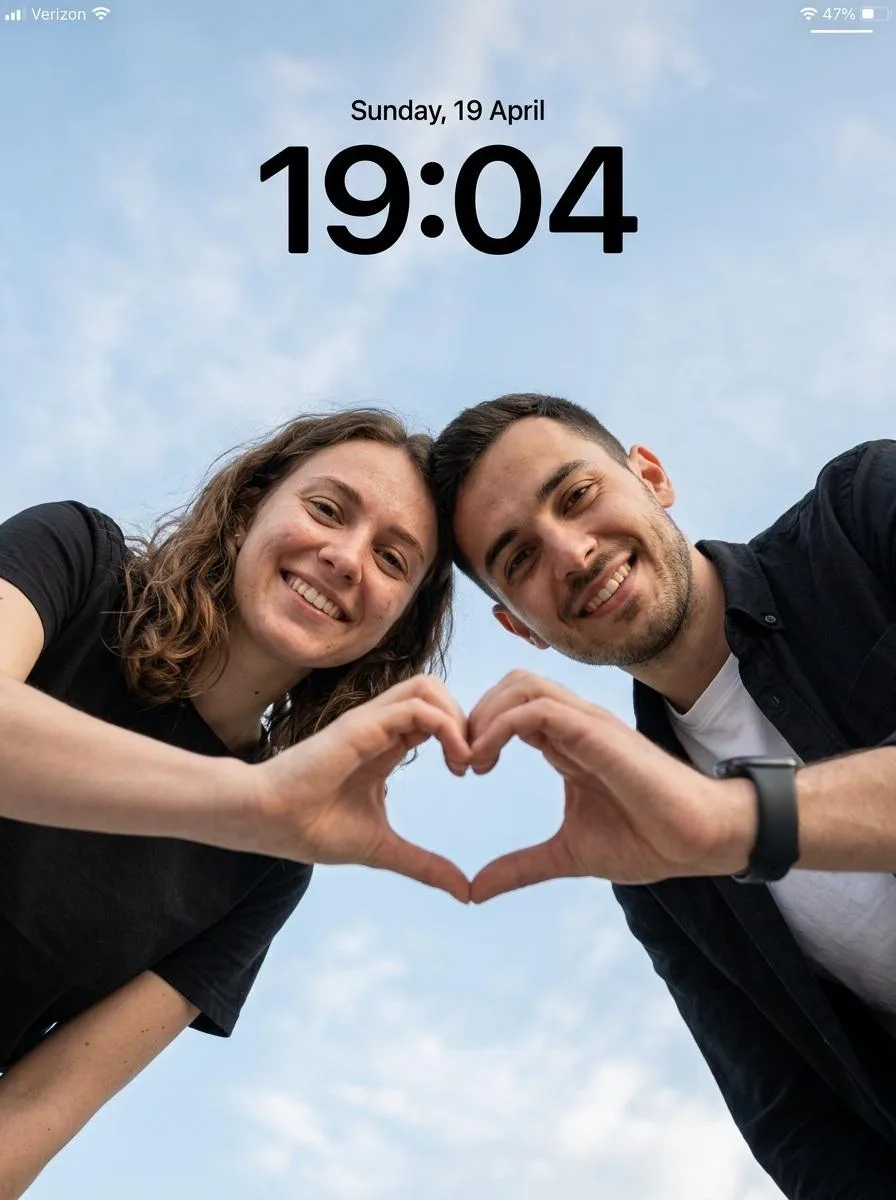 Create an ultra-realistic cinematic low-angle couple portrait with a smartphone lockscreen UI overlay.