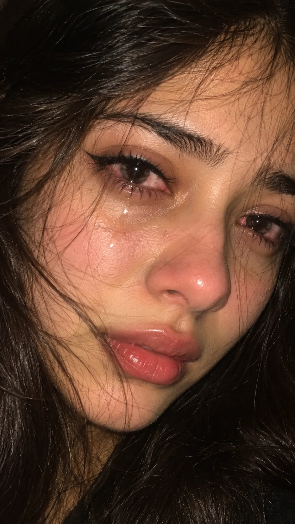 Create an ultra-realistic extreme close-up portrait of a young South Asian woman, framed vertically in a 9:16 aspect ratio, with only her